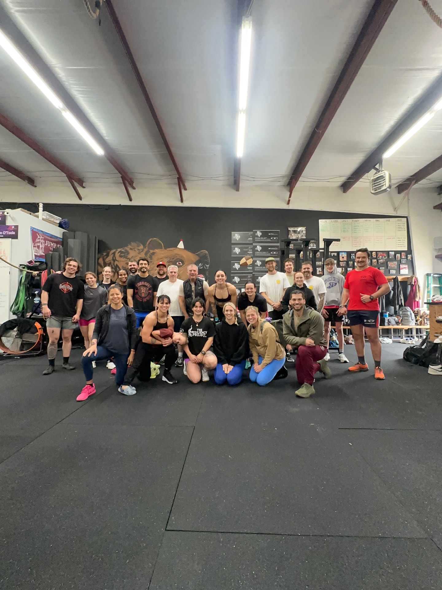 Members gathered inside a gym wearing Resiliency Project shirts